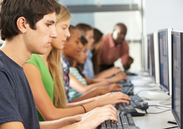 Stock photo of students in computer lab.